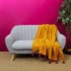 TOILINUX Jeté De Canapé Surpiqué Avec Pompons Jaune Et Rose -Maisons Du Monde Boutique jete de canape surpique avec pompons jaune et rose